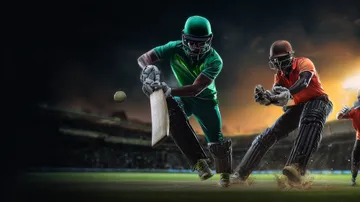 A man celebrating a winning moment on his laptop while gaming symbols float around him, capturing the excitement of CD44 games.